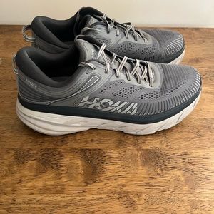 Used Hoka Bondi 7 men’s running/walking shoes.  Size 12 US.  Grey.